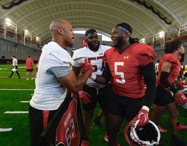 Governor Wes Moore poses with Maryland defensive lineman Quashon Fuller during the team's practice. (Kenneth K. Lam/staff)